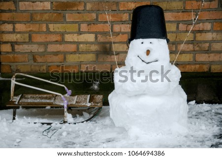 Snowman bucket sled