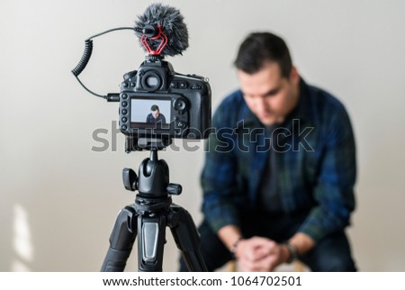White blogger recording video of himself
