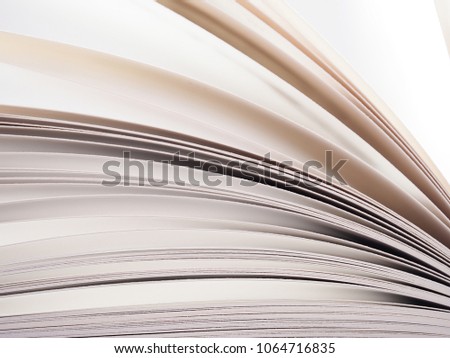 Concept of open book. Macro view of book pages, white sheets on grey and white background. Education background. Close-up, selective focus