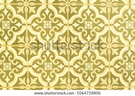ancient vintage gold ceramic tiles on cement wall decoration