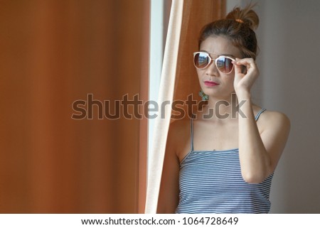 Asian women standing by window background.