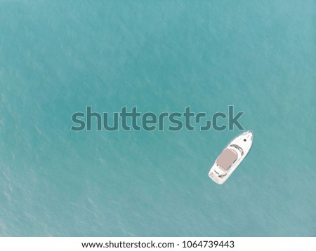 Aerial view of yacht on blue ocean with blank space