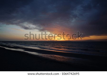 Calm sea with the golden sunset sky