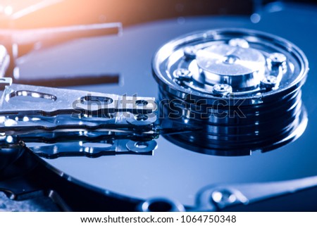 The abstract close up image of inside of hard disk drive on the technician's desk. the concept of technology, hard drive, industry, data, hardware, and information technology.