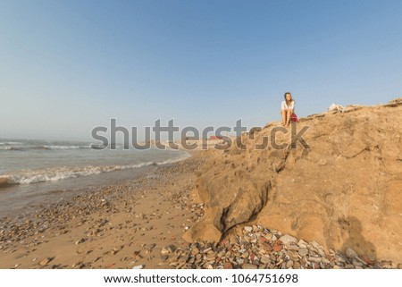 tourist caucasian girl in Essaouira beach, Morocco