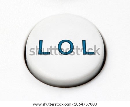 A white round button switch for emotional sign LOL (laughing out loud or lots of love), close up. Control mechanical key for emotion of user on control device.