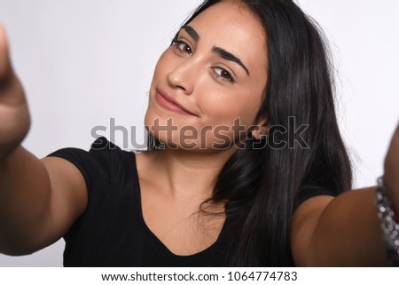 Close-up of young beautiful woman taking selfie. Isolated white background