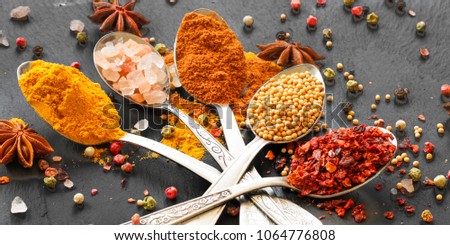 Spices and herbs. Variety of spices and herbs on a wooden surface

