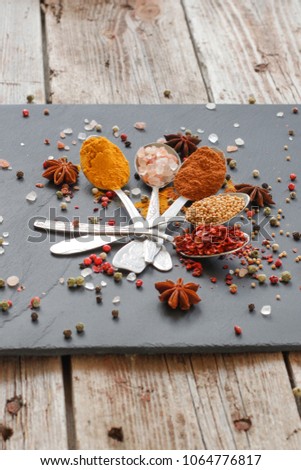 Spices and herbs. Variety of spices and herbs on a wooden surface
