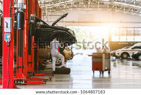 black car repair station with soft-focus and over light in the background Royalty-Free Stock Photo #1064807183