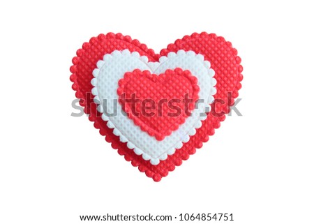 A beautiful red-white heart made of cloth. Close-up. Isolated on white background.
