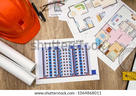 orange helmet, construction drawing, calculator, pen