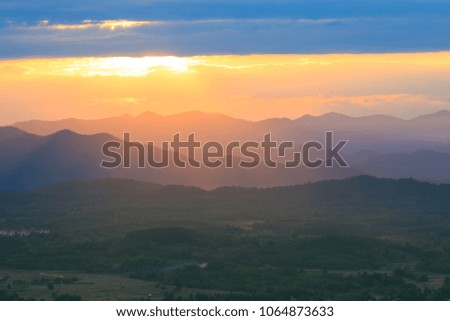 Dark landscape with mountains at sunset