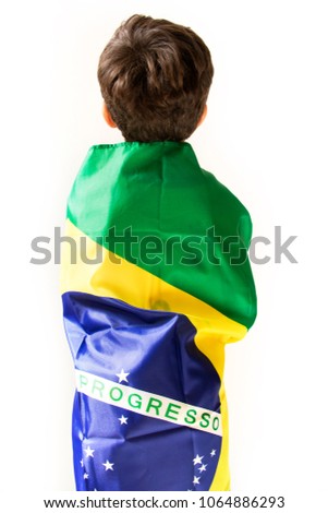 Cute boy with Brazilian flag. Back view over white background.