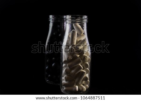 Black and white candy in seperate jars to a black background; symbolizing lack of diversity