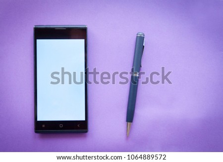 smartphone business fountain pen on purple background Flat lay Business workplace and objects. Top view. Copy space for text