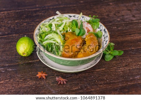Vietnamese Corn-fed Chicken with vermicelli noodles on wooden table