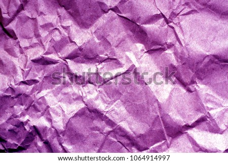 Old paper with wrinckles in purple color. Abstract background and texture for design.