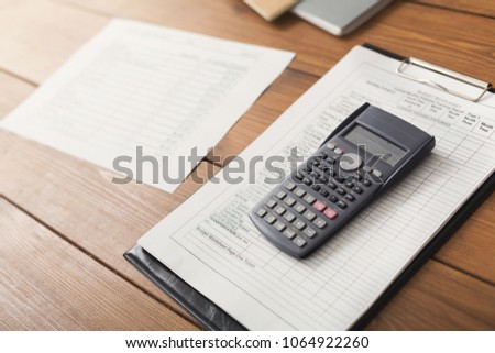 Office table with calculator and documents. Financial background, count and pay an account, copy space