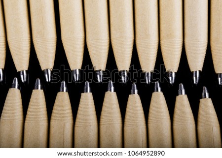 set of beige pens mockup design on black dark wooden background