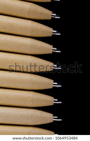 set of beige pens mockup design on black dark wooden background