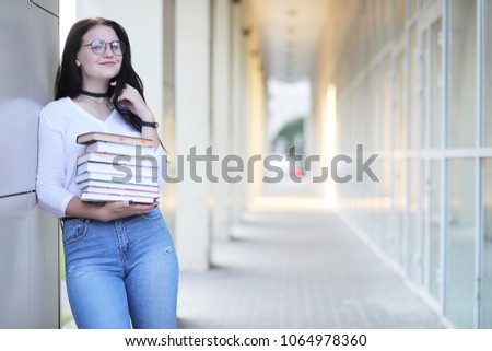Girl student on the street with books