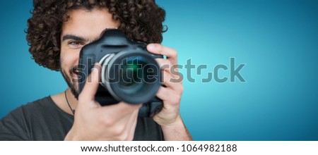Composite image of close up portrait of male photographer taking picture