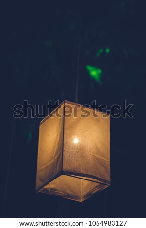 Colorful of classic paper lantern and light blub in thai night garden public park  blurred background of light in New Year and party celebration festival.Vintage nigh flim grain Style.