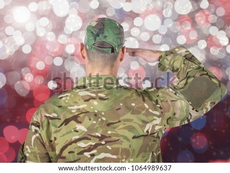 Military saluting against glowing background