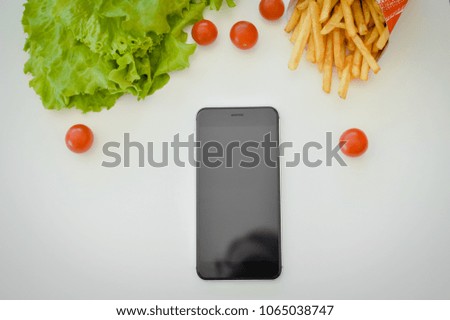 Salad food background, close up top side view picture. Modern communication technology and delicious healthy lifestyle