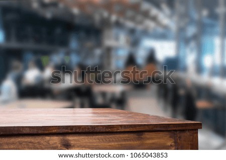 Selected focus empty brown wooden table and Coffee shop or restaurant blur background with bokeh image. for your photomontage or product display