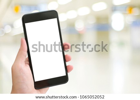 Hand using smart phone with blank screen over blur bokeh light background, business and technology, internet of things concept