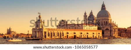 Venice at sunset, Italy. Grand Canal with the Basilica di Santa Maria della Salute - landmarks of Venice. Panoramic sunny view of Venice in summer. Horizontal banner of nice Venice for website header.