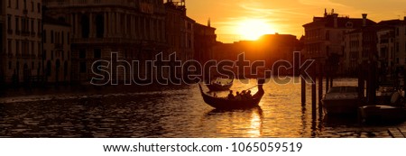 Landscape of Venice at night, Italy.  Panorama of Venice at sunset, gondolas sail on Grand Canal, romantic water trip in evening. Night view of city and sun for background. Travel and tourism theme