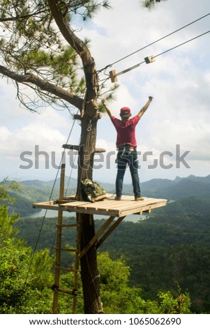 A man feel very happy when he can reach top of the tree. This photo was taken in banyu biru, Central java, Indonesia