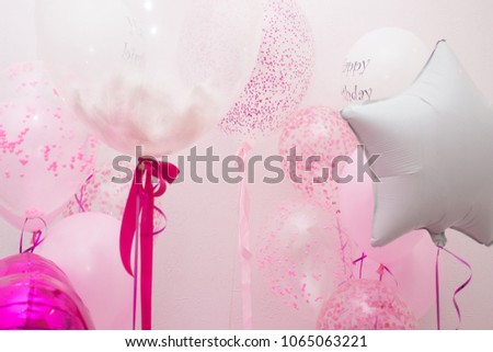 Group of white and pink balloons of different shapes in holiday on light background