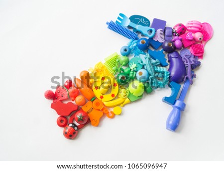 Game for the child in the form of an arrow rainbow color. Index sign consisting of children's toys. Concept. Children's club for the toddler.