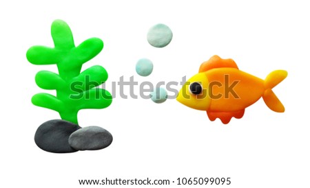 Plasticine cute orange sea fish and coral green isolated on a white background. Clipping path.