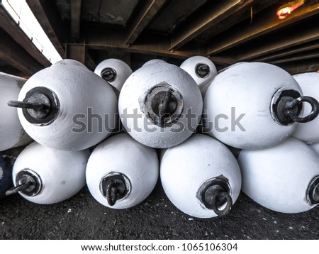 Closeup view of white water buoys or flotation markers piled up under lake shore drive bridge near Randolph Street in Chicago.