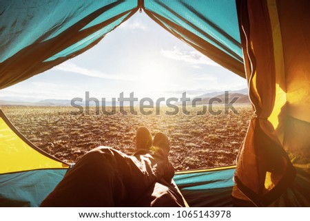Closeup photo of legs in tent. Travel trekking expedition concept