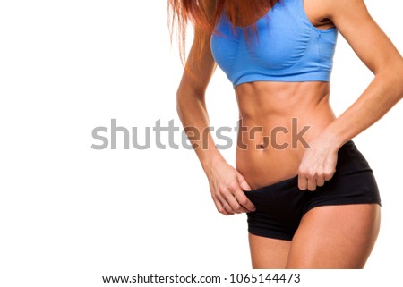 young female body in fitness sports clothing. Athletic woman. isolated on white background. abs