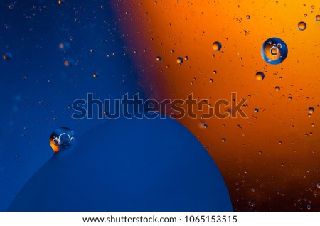 Oil drops on water surface abstract background.