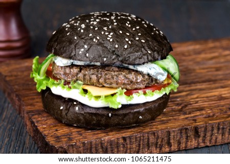fresh tasty burger on wood table