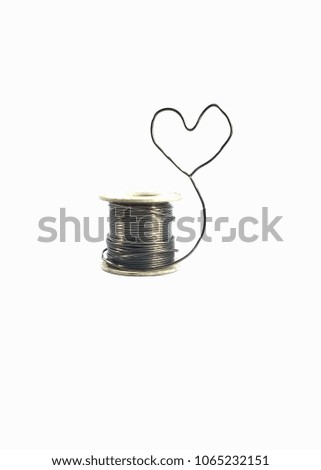 Heart shape made of lead solder. White background