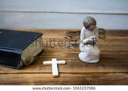 a angel old bible and cross