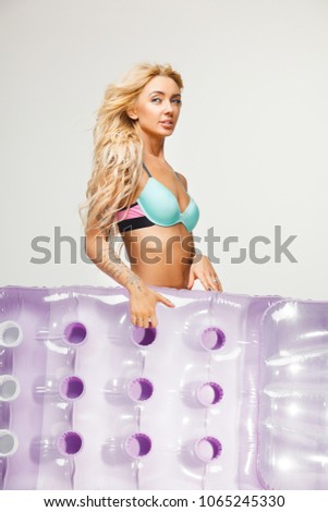 beautiful female photo of young woman with slender body wears bikini holding swimming mattress on white isolated. travel, rest, vacation.