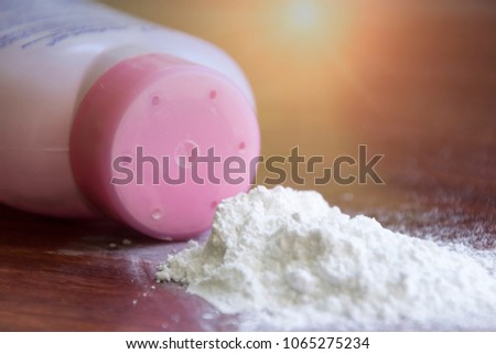 Baby talcum powder and their container are on wooden background with sunlight, dangerous from dust.
 Royalty-Free Stock Photo #1065275234