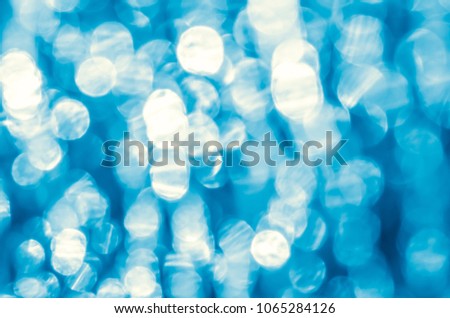 Lights on blue background - abstract photography useful for your design. Bright blue abstract christmas background with white snowflakes