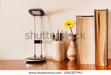 Education, Books and school supplies and lamp on wooden table background in concept back to school, vintage book and vintage style.