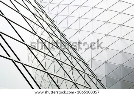 Geometric modern structural detail reflected on glass window facade